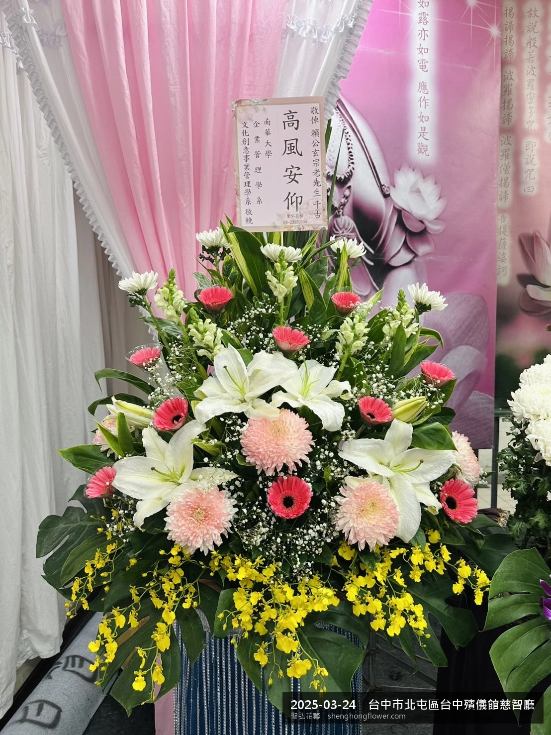 春暖氣候濕潤下，台中北屯台中殯儀館慈智廳前光線柔和。我們選用高架白菊花籃，雙劍蘭挑高、黃菊鋪底，現場顯得莊嚴端莊，誠摯傳達對家屬的關懷，聖弘花藝在地團隊現場實拍照。