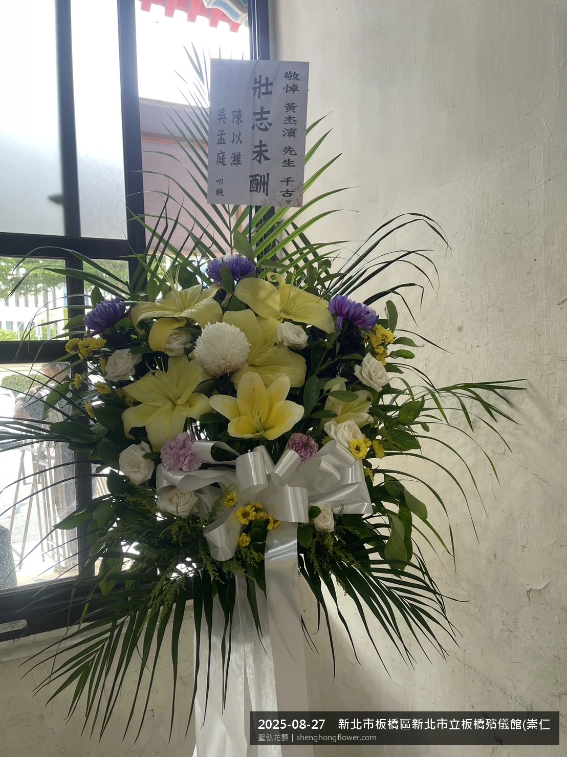 新北板橋新北市立板橋殯儀館(崇仁廳)前氣氛現場端正，選用高架白菊花籃並高架支架對稱、白菊圍裙裝飾，搭配夏末暑熱氣候漸轉的場景，於現場完成定位，聖弘花藝在地團隊現場實拍照。